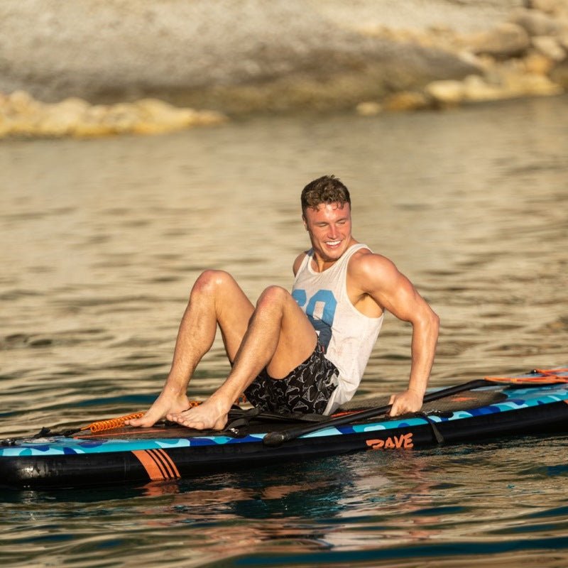 man sitting on top of his paddle board