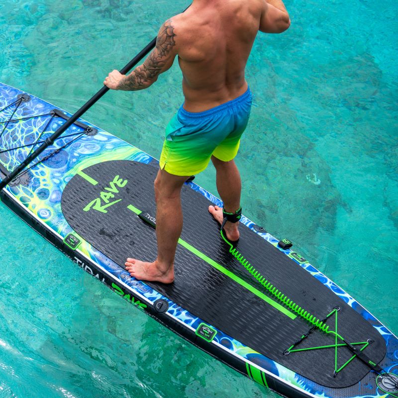 man holding his SUP paddle on top of his paddle board