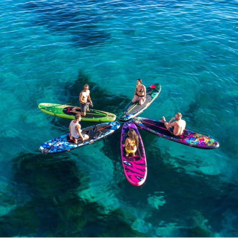 5 people sitting on top of their floating paddle boards