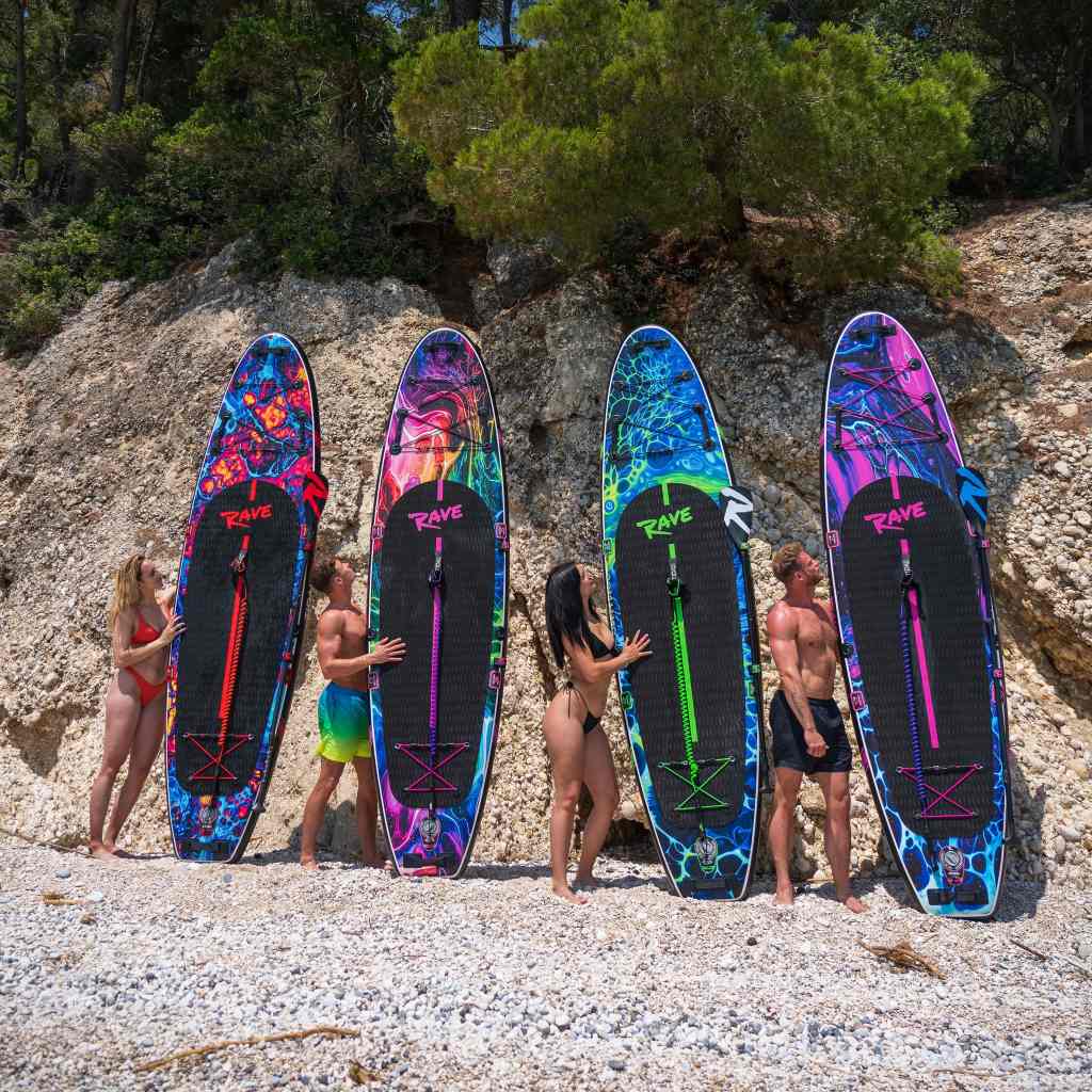 a group of people posing with their paddle boards