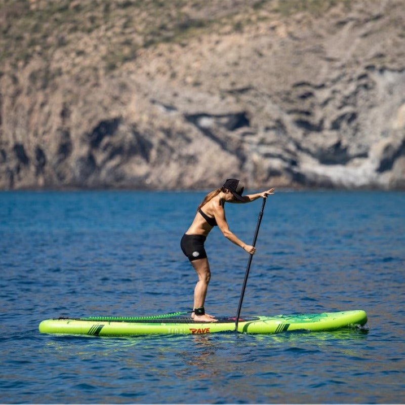 a woman rowing while standing on top of her paddle board