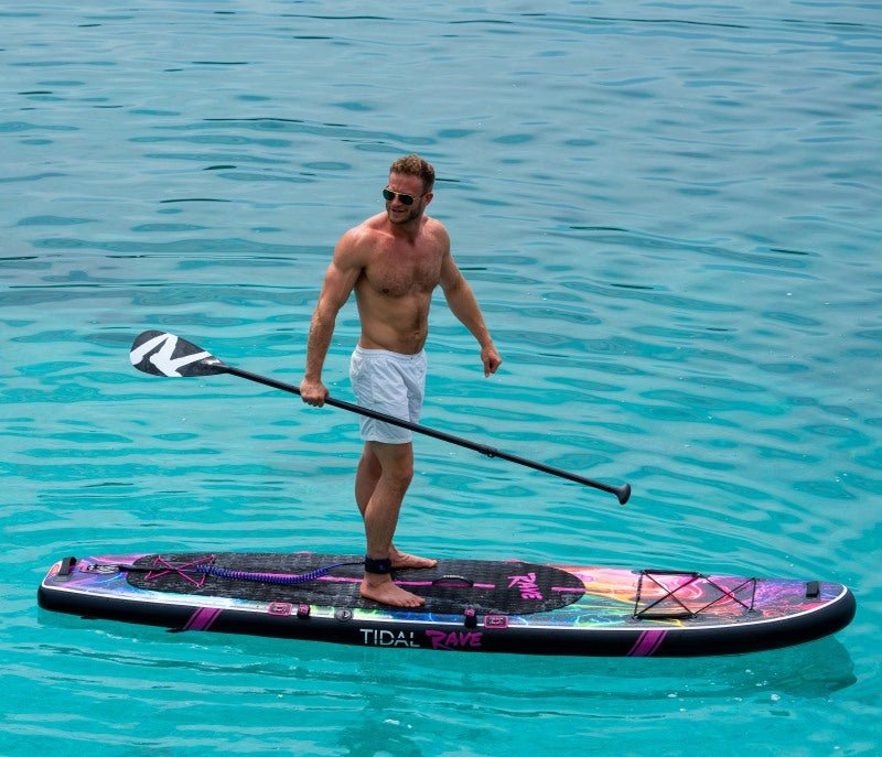 a man standing on top of his floating paddle board