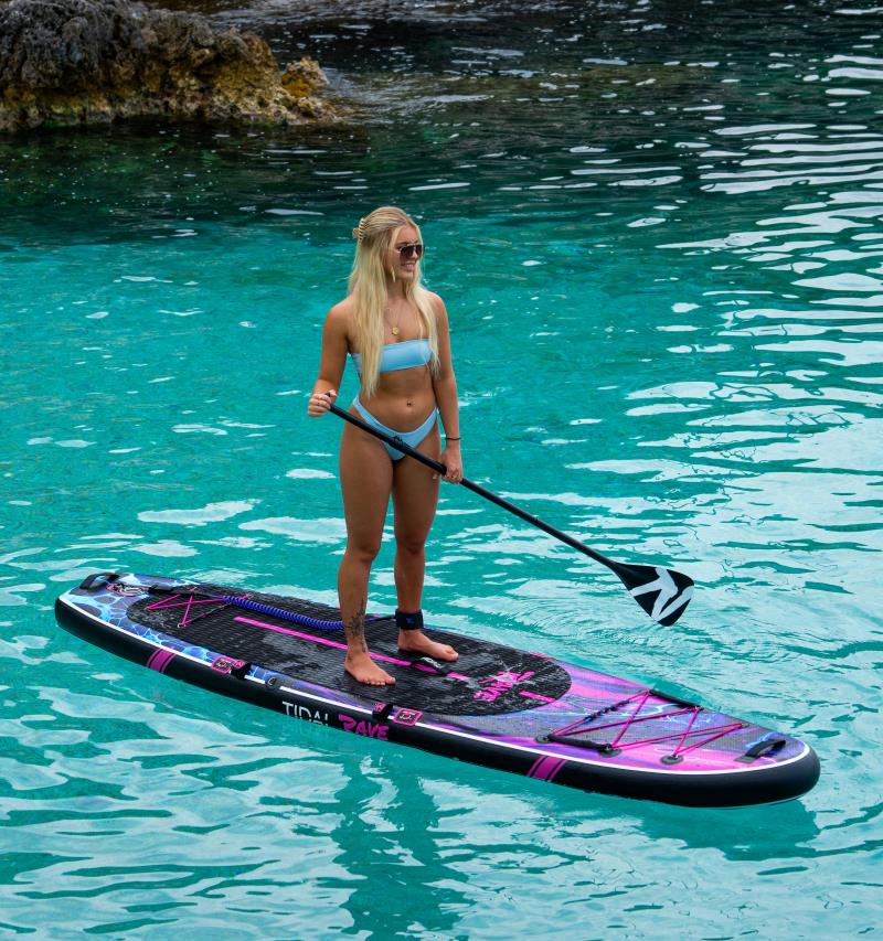 woman standing on top of her paddle board